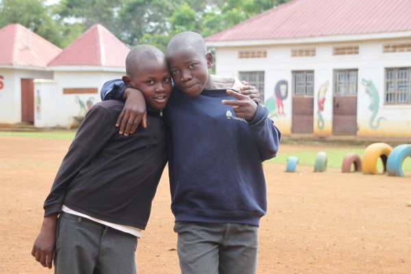 Two children outside the school